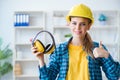 The woman in workshop with noise cancelling headphones