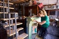 Woman In Workshop Upcycling And Working On Fire Surround