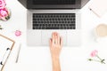 Woman workspace with female hands, laptop, pink roses bouquet, accessories, diary. Top view. Flat lay home office desk. Girl worki Royalty Free Stock Photo