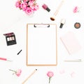 Woman workspace with pink roses bouquet, cosmetics, diary and clipboard on white background. Top view. Flat lay. Beauty or fashion Royalty Free Stock Photo