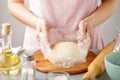 Woman wrap the dough in the package.