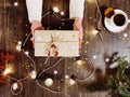 Woman with wrapped present above table