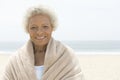 Woman Wrapped In Towel Standing On Beach Royalty Free Stock Photo