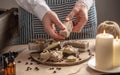 Woman is wrapping a beautiful natural soap decorated with coffee beans. Concept of interesting hobby and handmade gifts