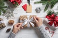 Woman wrapping Christmas gift at wooden table Royalty Free Stock Photo