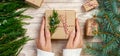 Woman wrapping modern Christmas gifts presents at home Royalty Free Stock Photo