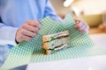 Close Up Of Woman Wrapping Sandwich In Reusable Environmentally Friendly Beeswax Wrap