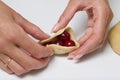 Woman wraps cherries in dough. Cooking dumplings. Close-up shot