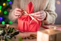 Woman Wrapping Christmas Gift In Eco Friendly Reusable Sustainable Cloth