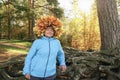 A woman with a wreath of yellow maple leaves on her head