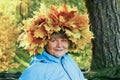 A woman with a wreath of yellow maple leaves on her head