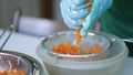 Woman wring out Grated carrots for cooking