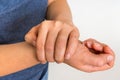 Woman with wrist pain is holding her aching hand