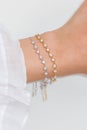 Woman wrist wearing zircon sparkle bracelets set against a white background Royalty Free Stock Photo