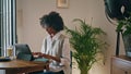 Woman writer typing laptop sitting cafe close up. African girl working computer Royalty Free Stock Photo