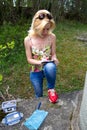 Woman writes in geocaching logbook