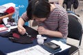 Woman writes Japanese Calligraphy at Animefest