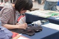 Woman writes Japanese Calligraphy at Animefest