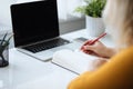 Woman writes in a diary in the office