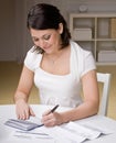 Woman writing checks from checkbook Royalty Free Stock Photo