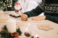 Woman writing Christmas cards with Santa claus pencil Royalty Free Stock Photo