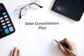 Woman writing debt consolidation plan in paper on desk. Copy space, top view Royalty Free Stock Photo