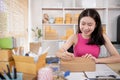 Woman is writing down the customer\'s details and addresses on the notebook