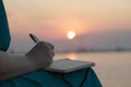 Woman writing in her diary at sunset Royalty Free Stock Photo