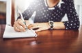 Woman, writing and home table with notebook and day schedule in a dinning room. Lens flare, female person and to do list Royalty Free Stock Photo