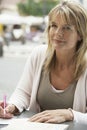 Woman Writing Letter At Outdoors Cafe Royalty Free Stock Photo