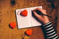 Woman writing love letter card for Valentines day