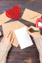 Woman writing love letter or romantic poem for Valentines day, top view of female hands. Valentine day concept with copyspace