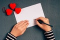 Woman writing love letter for Valentines day