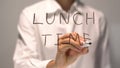 Woman writing Lunch Time on transparent screen. Businesswoman write on board.