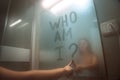 Woman writing on the mirror who am I. self awareness, identity or personality concept