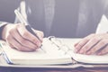 Woman writing on notebook close up view