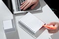 Businesswoman Writing In Notebook With Marker On Desk With Notes And Lap Top. Woman In Suit Holding Colored Pen Above