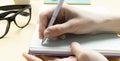 Woman writing notes on desk, close up of Royalty Free Stock Photo