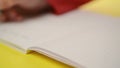 Woman writing notes in notebook, close up steady footage with selective focus on hand.