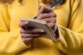 Woman writing notes in planner with pen. Girl thinking future plans to-do list Royalty Free Stock Photo