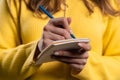 Woman writing notes in planner with pen. Girl thinking future plans, to-do list Royalty Free Stock Photo