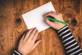 Woman writing recipient address on mailing envelope