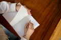 A woman writing something in a book at a table in a cafe. top view image Royalty Free Stock Photo