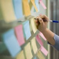 woman writing sticky notes office window. High quality photo Royalty Free Stock Photo