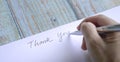 Woman writing thank you on card or paper Royalty Free Stock Photo