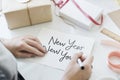 Woman writing a happy new year card Royalty Free Stock Photo