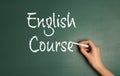 Woman writing words ENGLISH COURSE on chalkboard