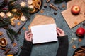 Woman writng a Christmas letter with gold pen. Royalty Free Stock Photo