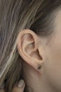 A woman& x27;s ear in close-up. Ear without lobe, earlobe type. Attached earlobes. Royalty Free Stock Photo