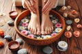 A woman& x27;s feet are in bowl of water with flowers and rocks Royalty Free Stock Photo